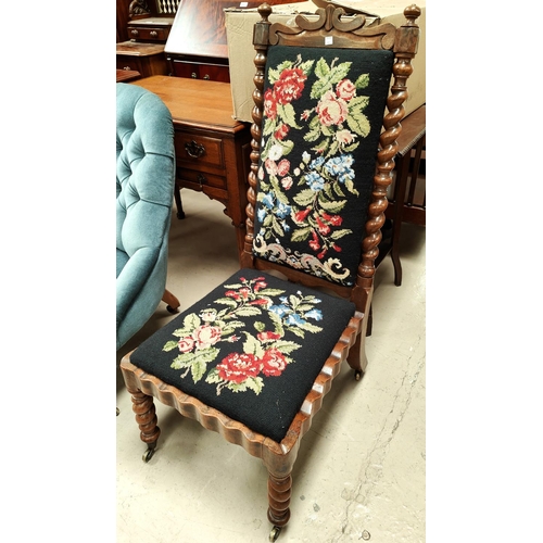 922 - A Victorian walnut prie-dieux style chair with barley twist side columns and needlework upholstery (... 