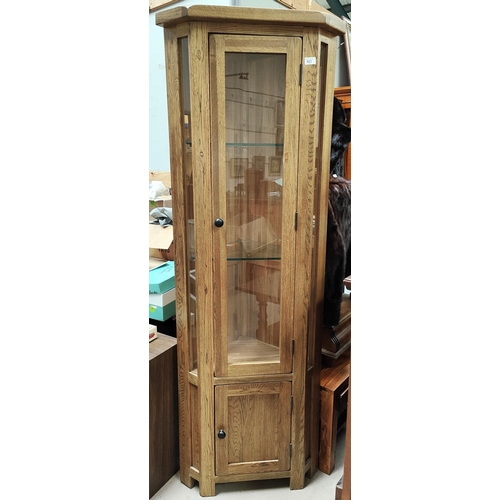 923 - A modern full height corner cupboard single display glazed door above and closed below