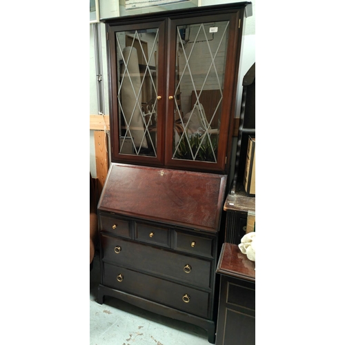 931 - A Stag bureau bookcase with fall front and drawers bellow