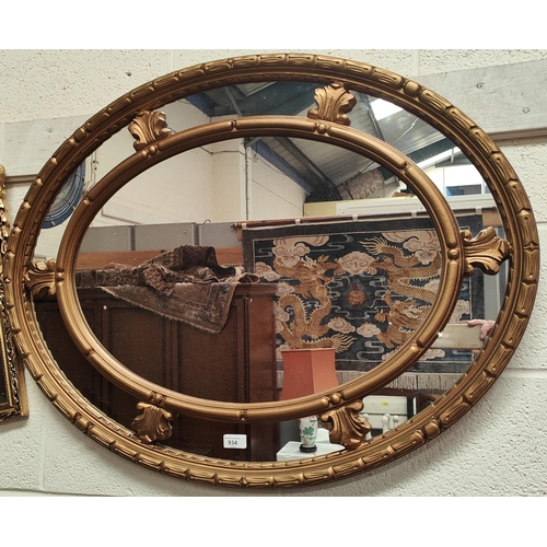 934 - A large oval framed mirror with gilt frame, 70x92cm