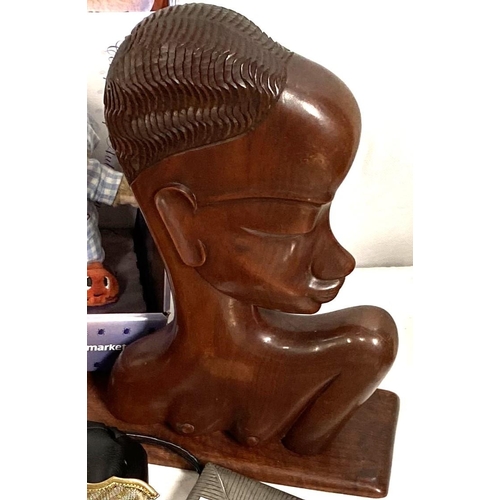 9A - An Art Deco carved wood head of an African woman, 36cm, 2 dress bags, tinplate toys etc
