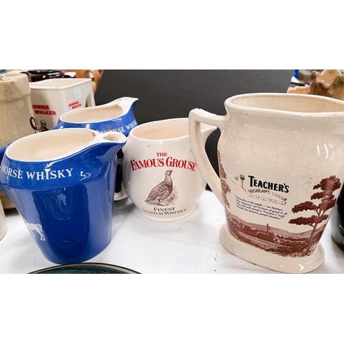 549 - A collection of approximately 20 whisky advertising jugs and related items