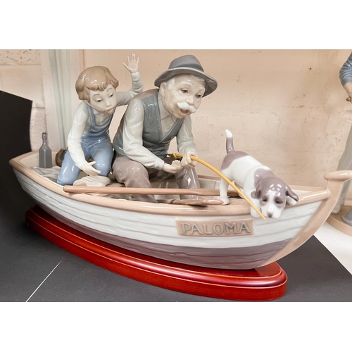 592 - A Lladro group:  grandfather and boy in a rowing boat, length 40cm