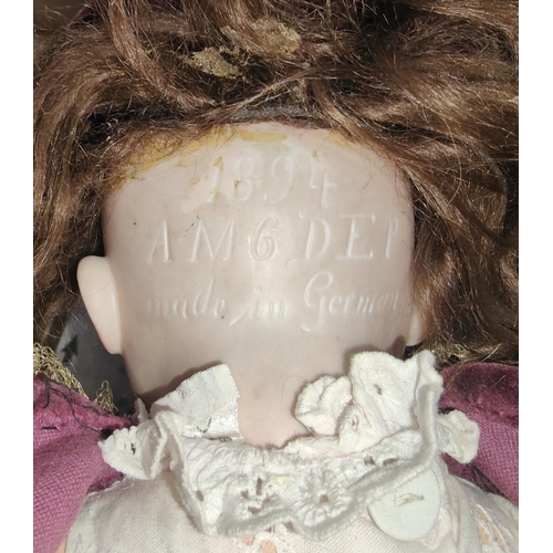 276 - A late 19th/early 20th century bisque head girl doll with sleeping glass eyes, composition body and ... 