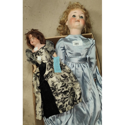 285 - A late 19th/early 20th century bisque head girl doll (head cracked), in blue satin dress, length 51c... 