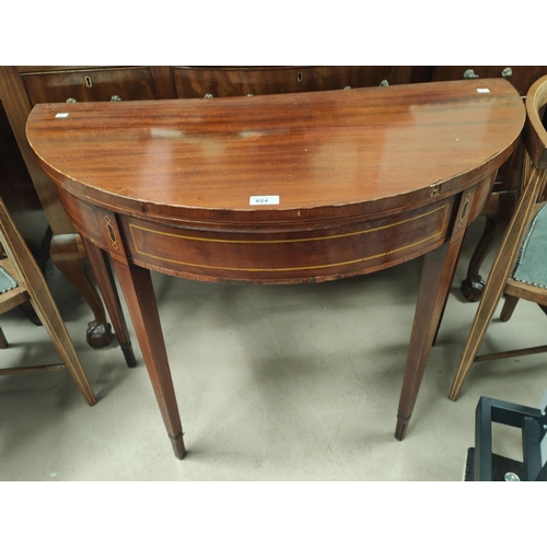 824 - A Sheraton style inlaid mahogany card table, the demi-lune fold over top with baize lining, on squar... 