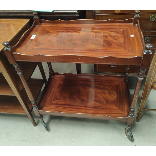 843 - A mahogany reproduction tea trolley with 2 tiers; an Edwardian mahogany Sutherland table