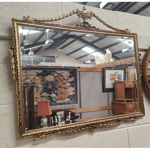 933 - A large gilt framed mirror with swag decoration, 58x86cm