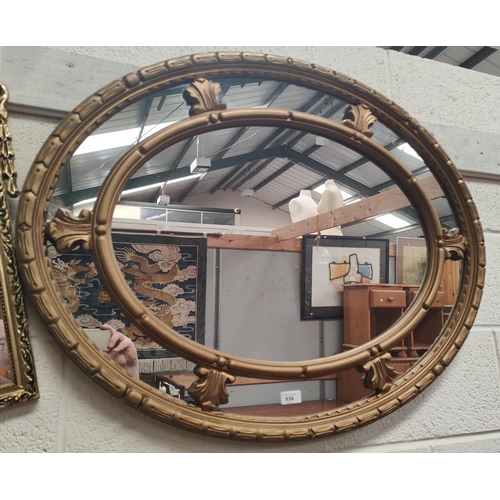 934 - A large oval framed mirror with gilt frame, 70x92cm