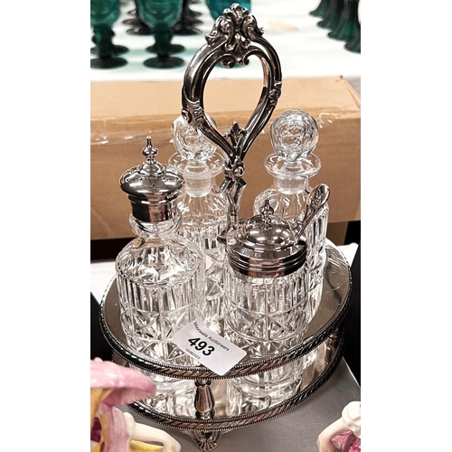 493 - A silver plated cruet set with cut glass ceramic figures etc.