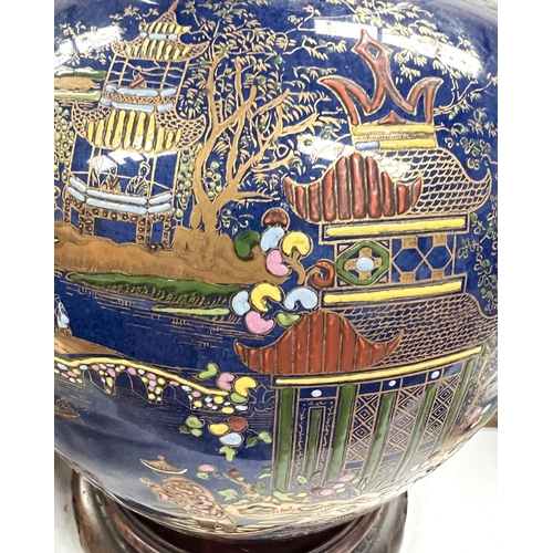 525 - A Carltonware large ginger jar decorated with a chinoiserie river scene on blue ground, height 26cm,... 