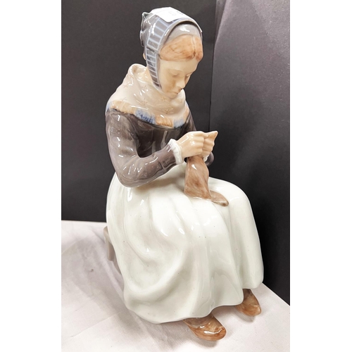 540 - A Royal Copenhagen figure:  Amish girl seated with sewing, height 15cm