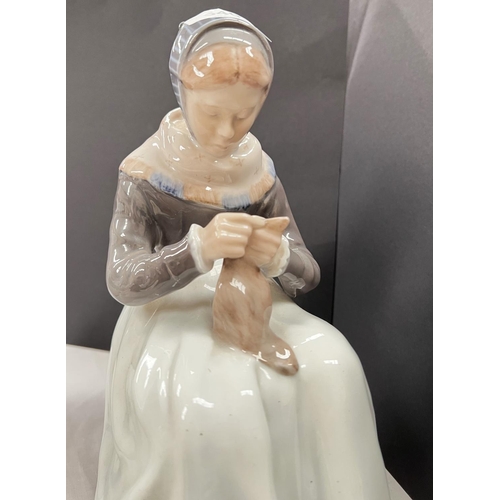 540 - A Royal Copenhagen figure:  Amish girl seated with sewing, height 15cm