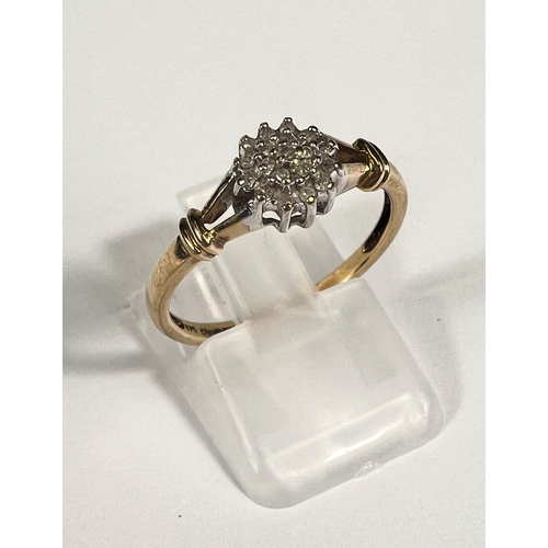 712 - A 9ct gold ring with diamond flower head, 19 stones, 1.8gm