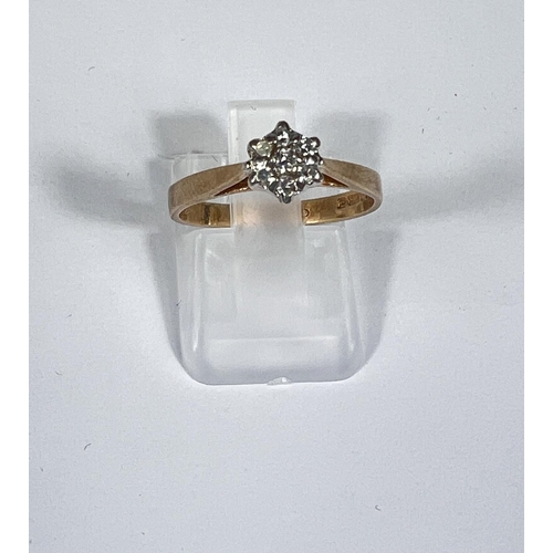 713 - A 9ct gold ring with diamond flower head, 7 stones, 1.9gm