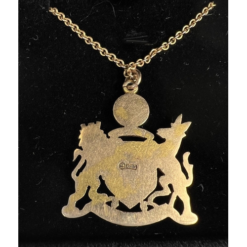 744 - An enamelled 15ct hallmarked gold pendant depicting the Manchester Coat of Arms 8.7gm on fine chain ... 