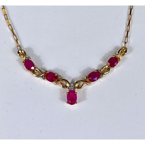 746 - A yellow metal necklace stamped '375' set with diamonds and rubies in 'V' formation, 4.5gm