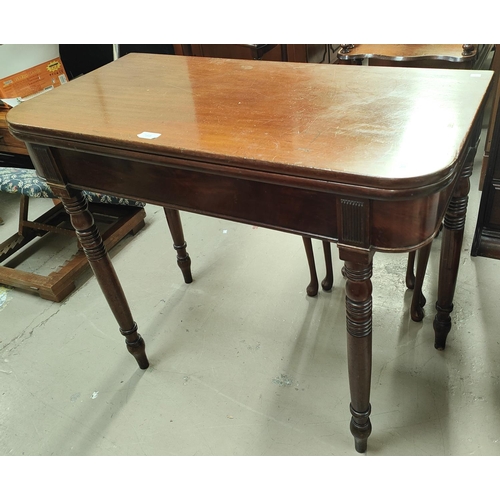 788 - A mahogany tea table with turned legs fold over rounded rectangular top