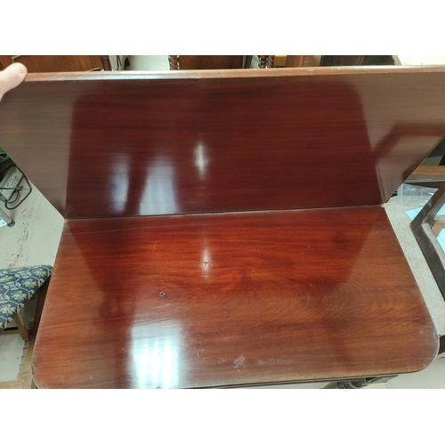 788 - A mahogany tea table with turned legs fold over rounded rectangular top