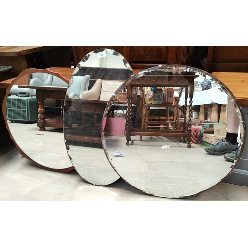 791 - Three vintage mirrors one circular with teak surround, one oval and one circular both with bevels ed... 