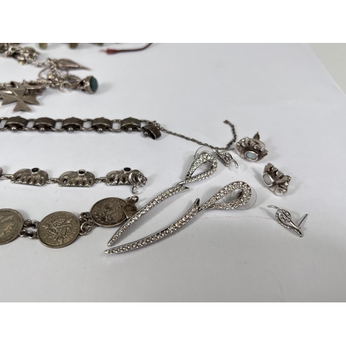 687 - A bracelet formed from 1930's 3d coins; a bracelet of white metal elephants each set with a blue sto... 