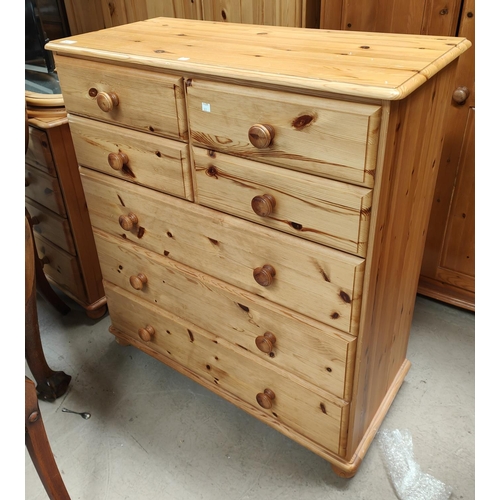 822 - A modern pine chest of 3 long and 4 short drawers; a 3-height bedside cabinet