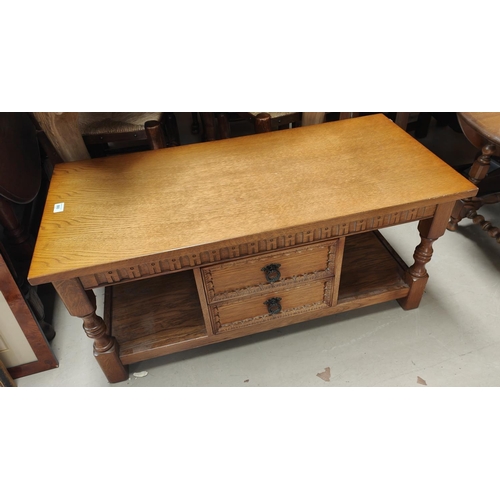 860 - A Jacobean style oak 2 tier occasional table with central drawers