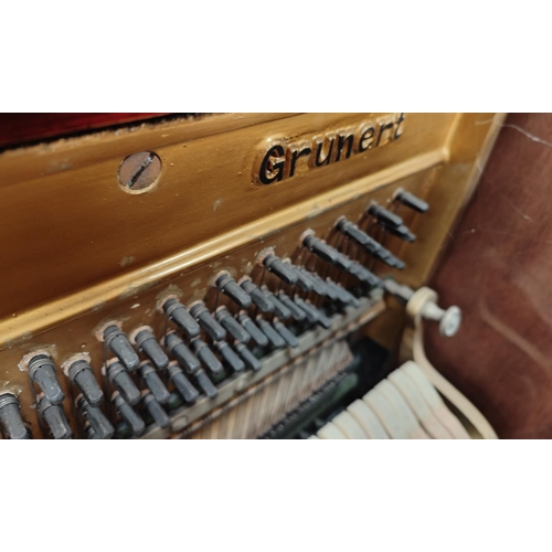 927 - A good quality Grunert overstrung mahogany cased upright piano with double headed eagle badge to fra... 