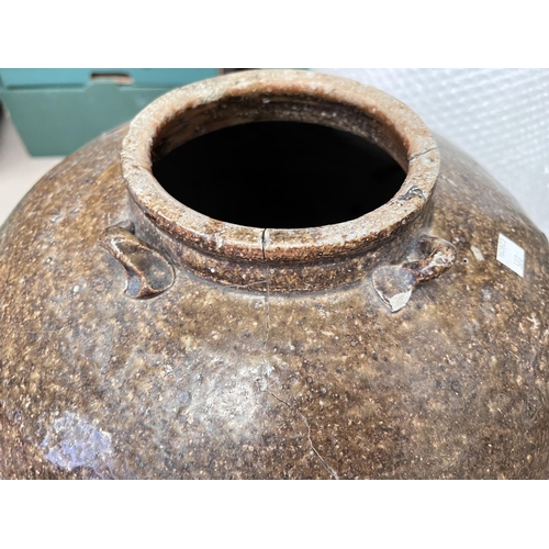 580 - A large stoneware ovoid pot, height 51cm (rim cracked)