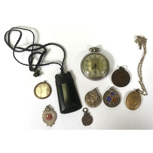 661 - An open faced, keyless pocket watch by Westclox; a gold plated locket; a jade coloured axe shaped pe... 