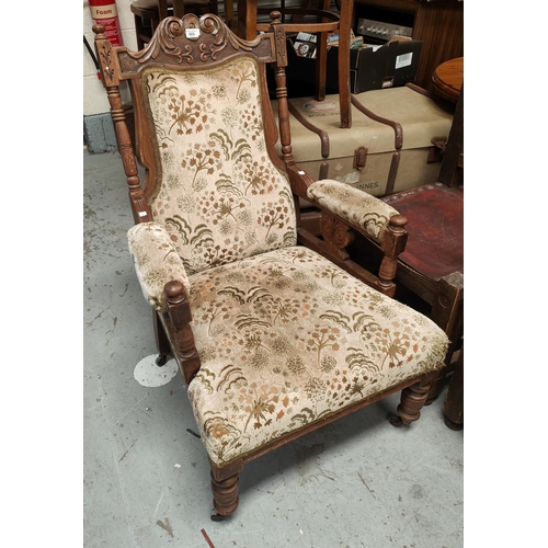 865 - An Edwardian walnut armchair in floral upholstery