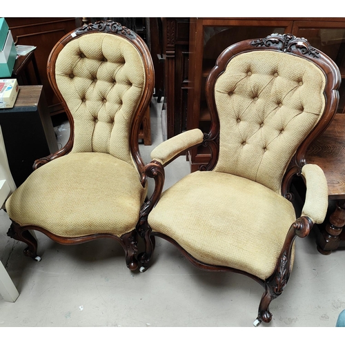 1056 - A Victorian pair of ladies and gents spoon back chairs in carved walnut on knurled feet and cas... 