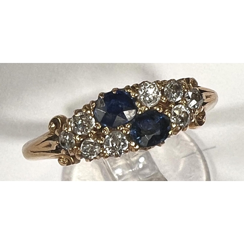 744 - A ladies dress ring set 2 sapphires and 8 diamonds, 18 carat gold shank