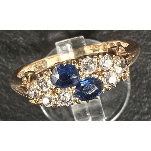 744 - A ladies dress ring set 2 sapphires and 8 diamonds, 18 carat gold shank