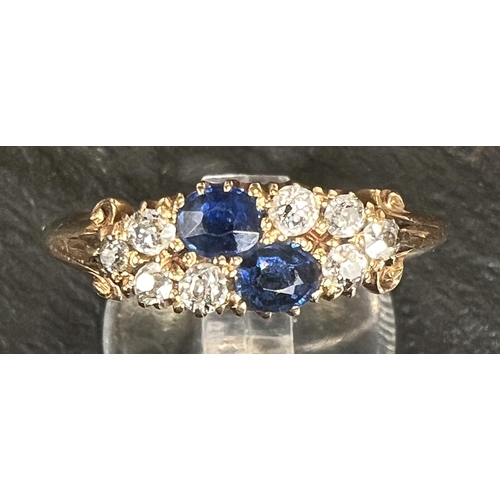 744 - A ladies dress ring set 2 sapphires and 8 diamonds, 18 carat gold shank