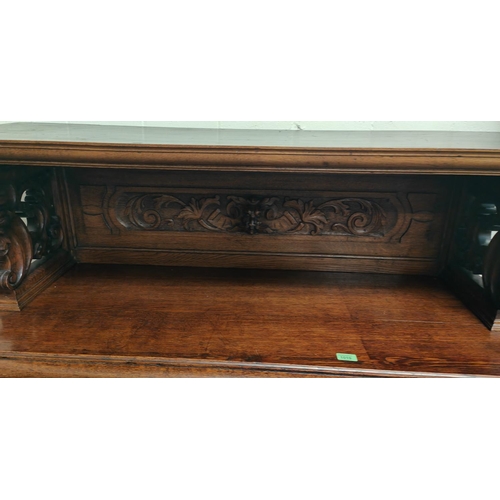 1019 - A Victorian Gothic extensively carved oak buffet sideboard with shell icons, head and paws carving w... 