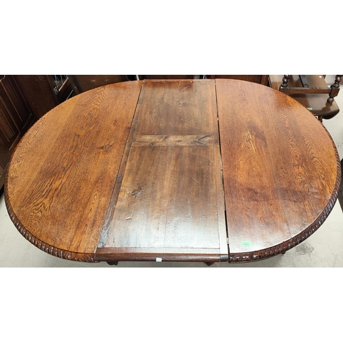 1020 - A Victorian heavily carved oak dining table with heavy three footed pedestal column rose carving cir... 