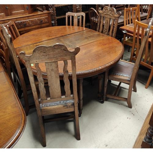 1020 - A Victorian heavily carved oak dining table with heavy three footed pedestal column rose carving cir... 