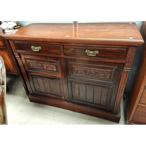 1051 - An Edwardian mahogany sideboard with carved and panelled doors and two drawers 96 x 118cm