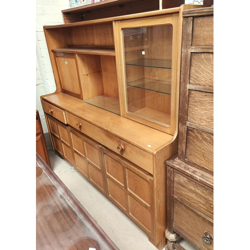 1061 - A mid 20th century high back teak side board cupboards and drawers bellow with fall front cocktail s... 