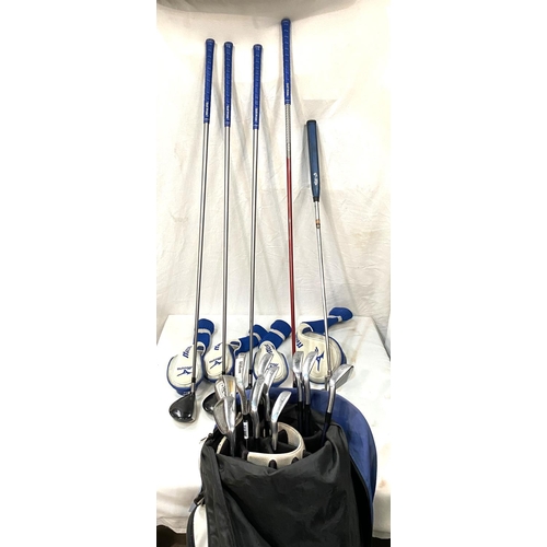27 - A golf bag containing a part set of clubs including 4 woods and 10 irons