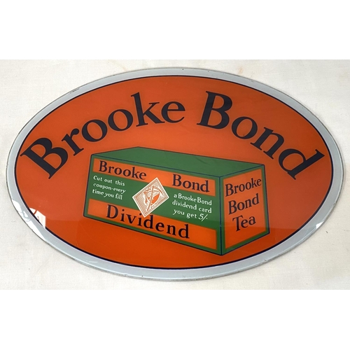 3 - Advertising: A Brooke Bond oval glass shop display sign, length 39cm; a card Quaker Oats shop sign, ... 