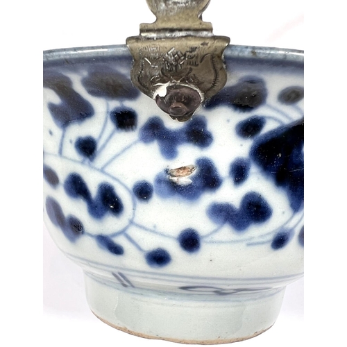 403 - A Chinese 18th century blue and white bowl with floral decoration to the outside, mark to base with ... 