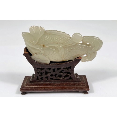 432 - A Chinese jade coloured hardstone carving of a fish on associated stand, length 9cm