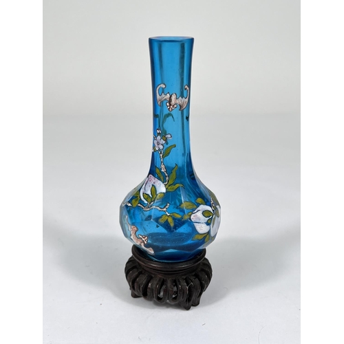 434 - A Chinese light blue glass vase with decoration of fruit and bats on trees with signature to base an... 