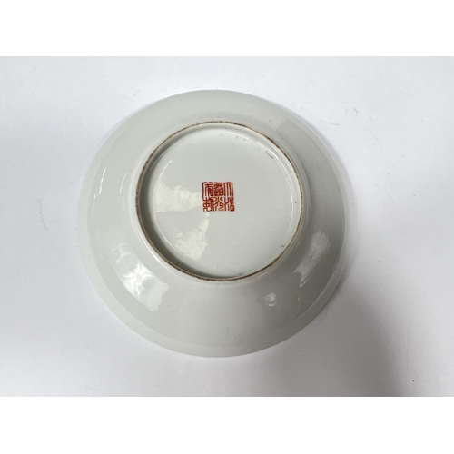 442 - A Chinese saucer with polychrome decoration of .... and gifts with text, dia. 13.5cm