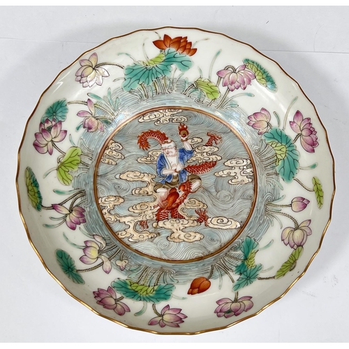 443 - A finely decorated Chinese saucer with polychrome decoration of deity riding dragon with floral bord... 