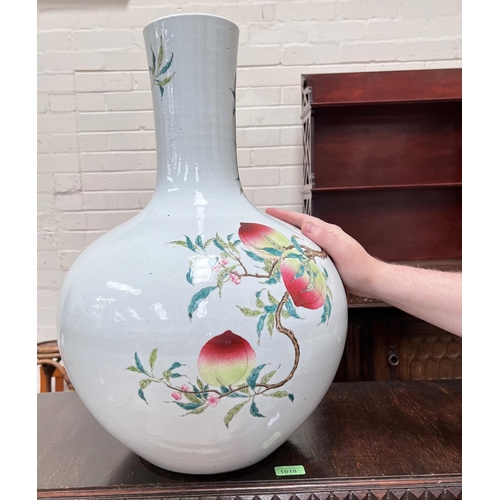 455 - A very large Chinese bottle vase decorated with polychrome peaches and flowers on branches with seal... 