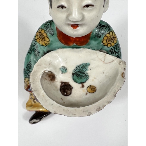 461 - A Chinese ceramic polychrome figure of seated girl holding very large oyster shell decorated with se... 