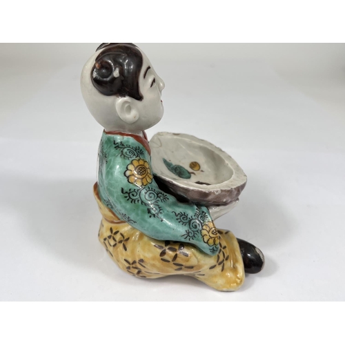 461 - A Chinese ceramic polychrome figure of seated girl holding very large oyster shell decorated with se... 